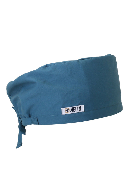 Calot médical turquoise, couvrant avec étiquette blanche et fermeture à nouer