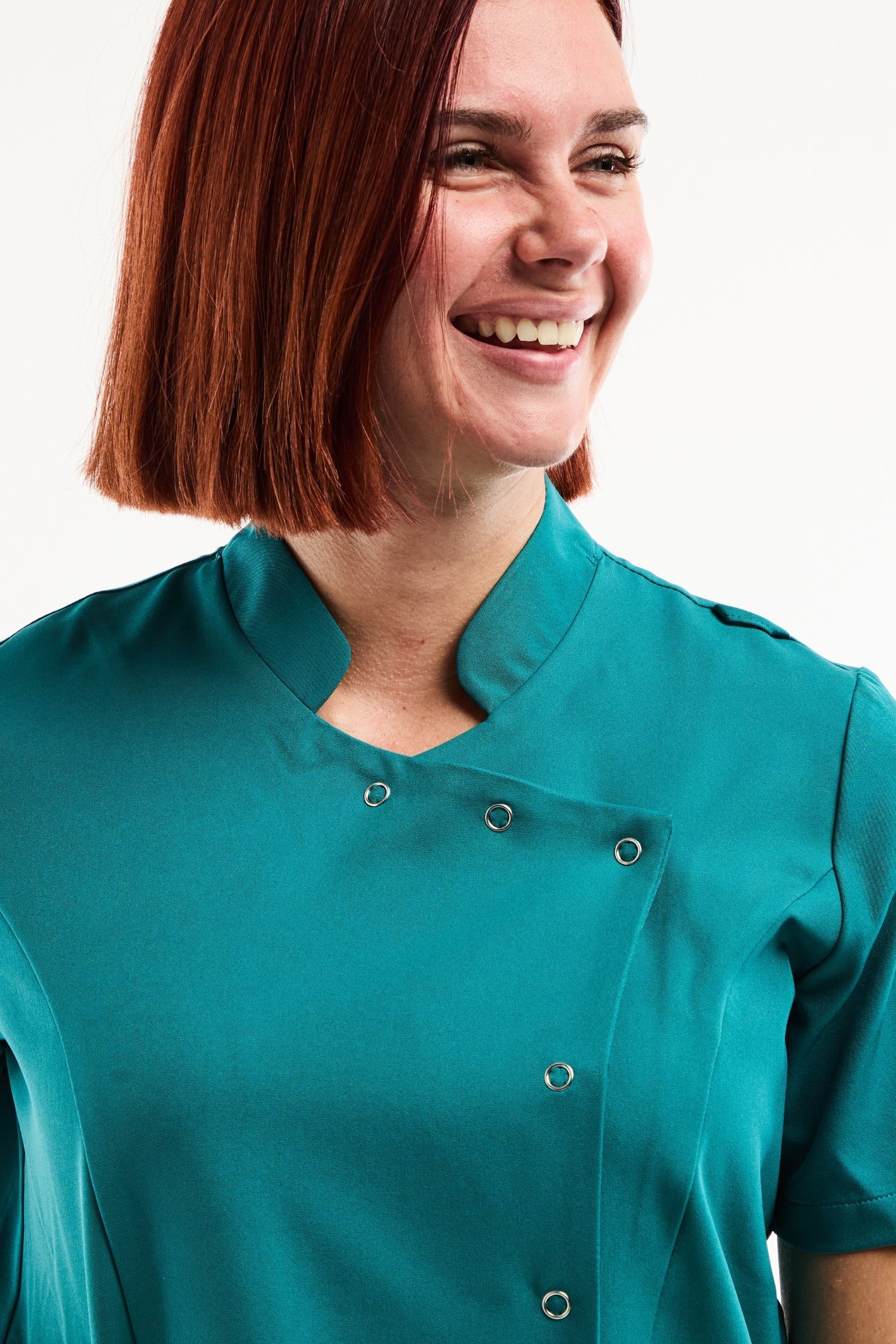 Blouse médicale Aurelia femme en bleu turquoise, col officier asymétrique à pressions