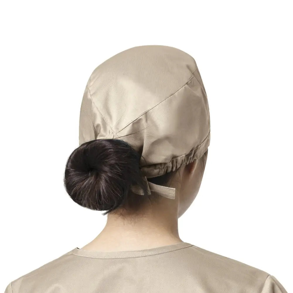 Femme portant un calot médical WonderWink beige, facile à entretenir contre les contaminations