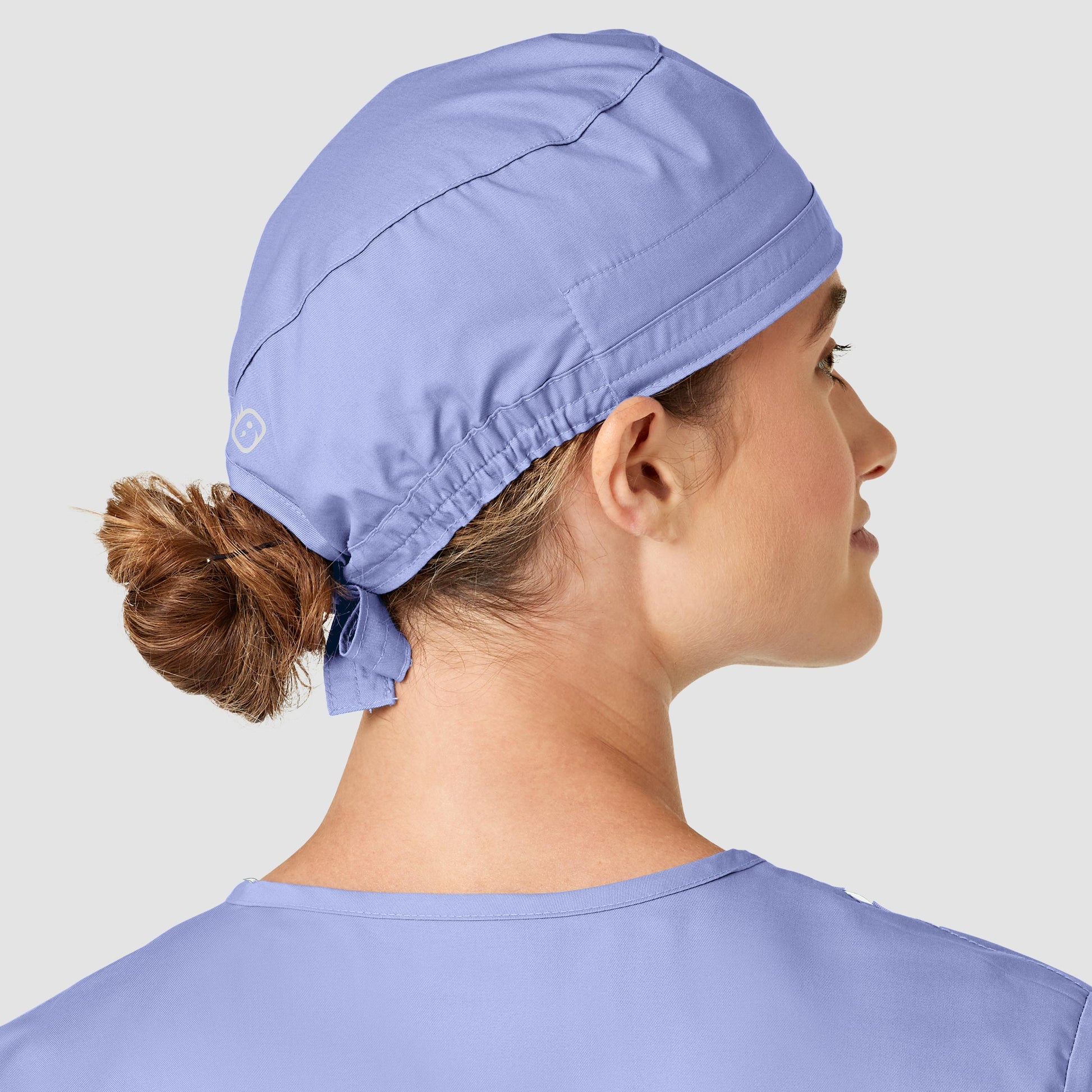 Femme portant un calot médical WonderWink Bleu ciel, facile à entretenir et anti-contaminations