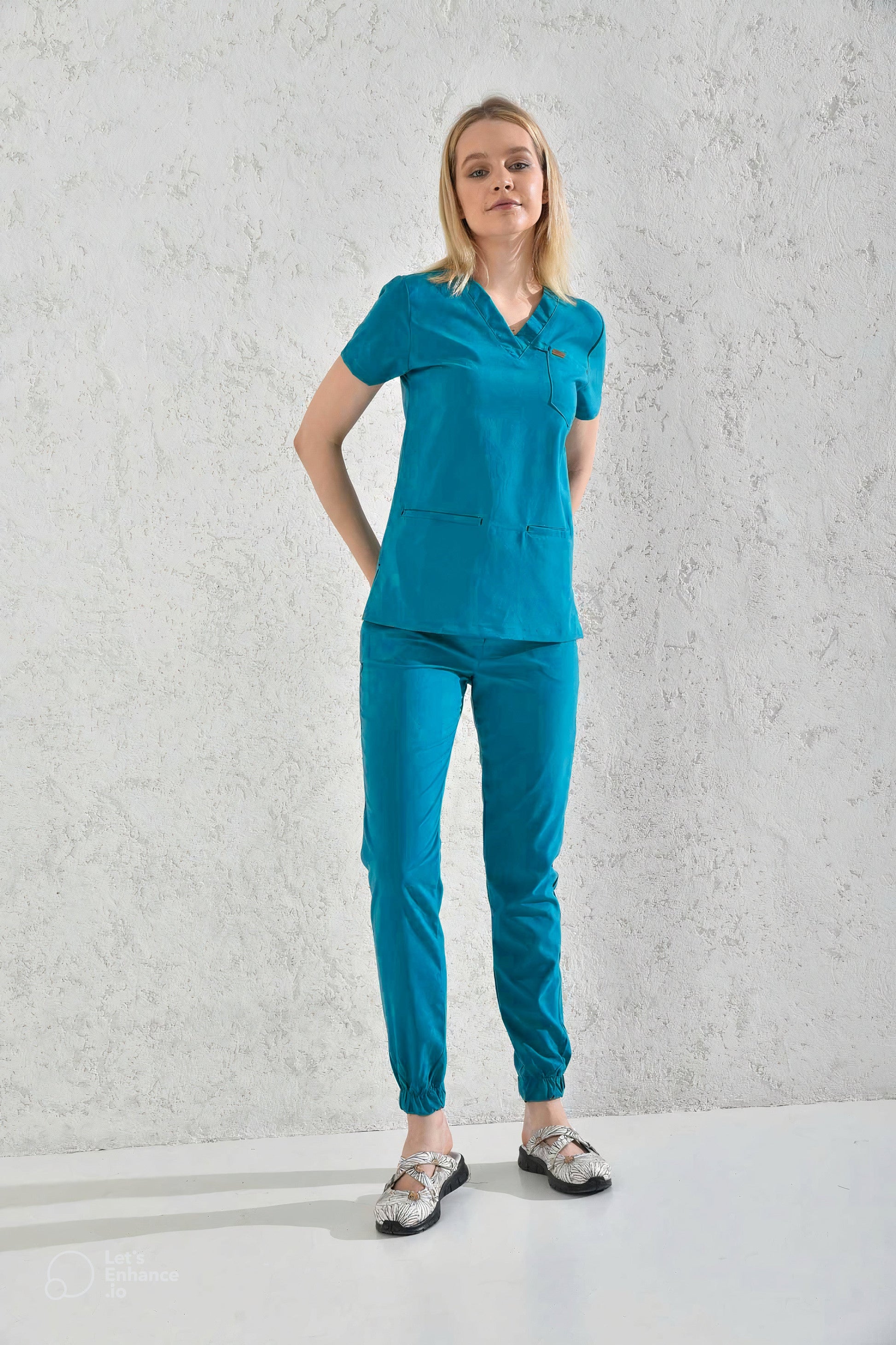 Femme portant un pantalon médical bleu cyan sous la tenue médicale Slimfit